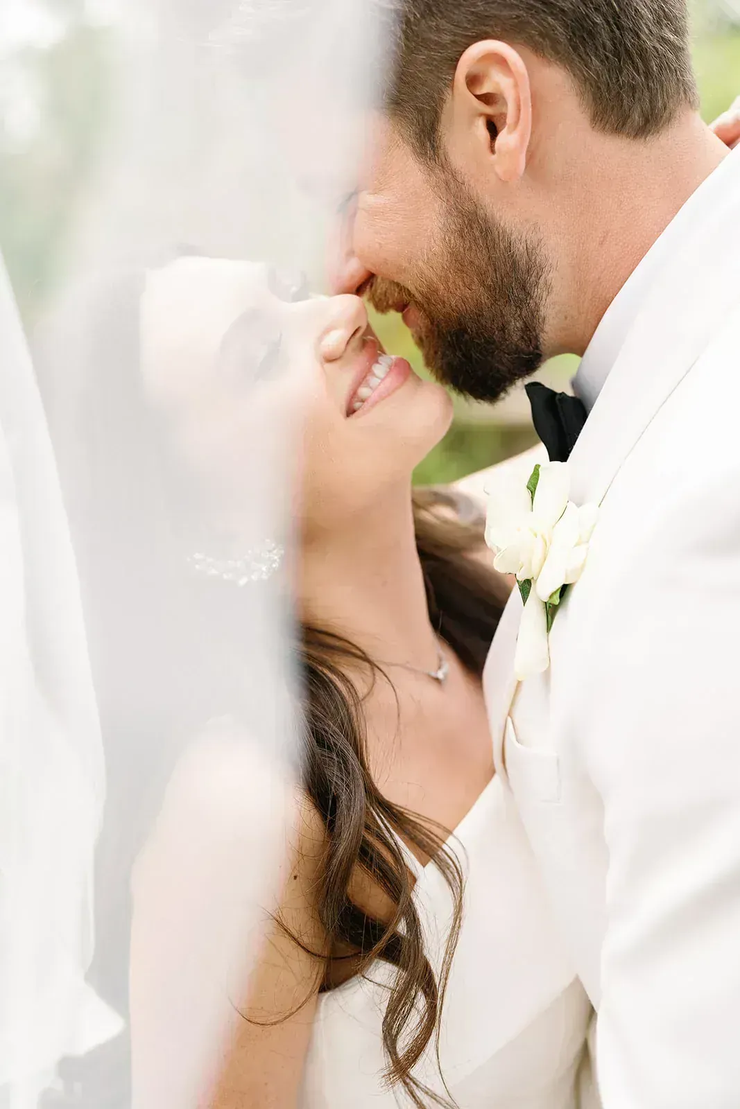 Intimate bride and groom portrait under veil
