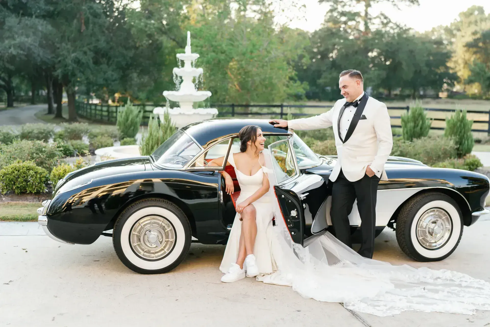 Bride and groom with vintage car at Texas Hill Country wedding